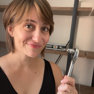 Paige brandishes the ratchet that made her bookcase assembly 432% faster.