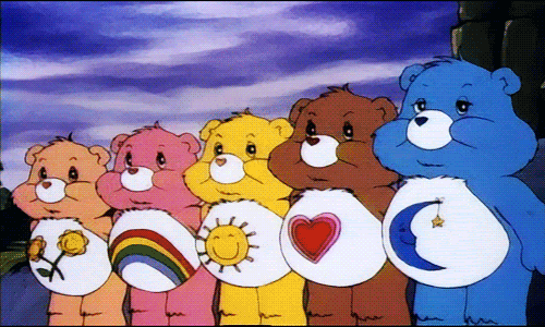 A line of Care Bears shine rainbow lights out of their tummies to spread love and happiness.